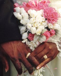 man and women holding hands showing wedding rings